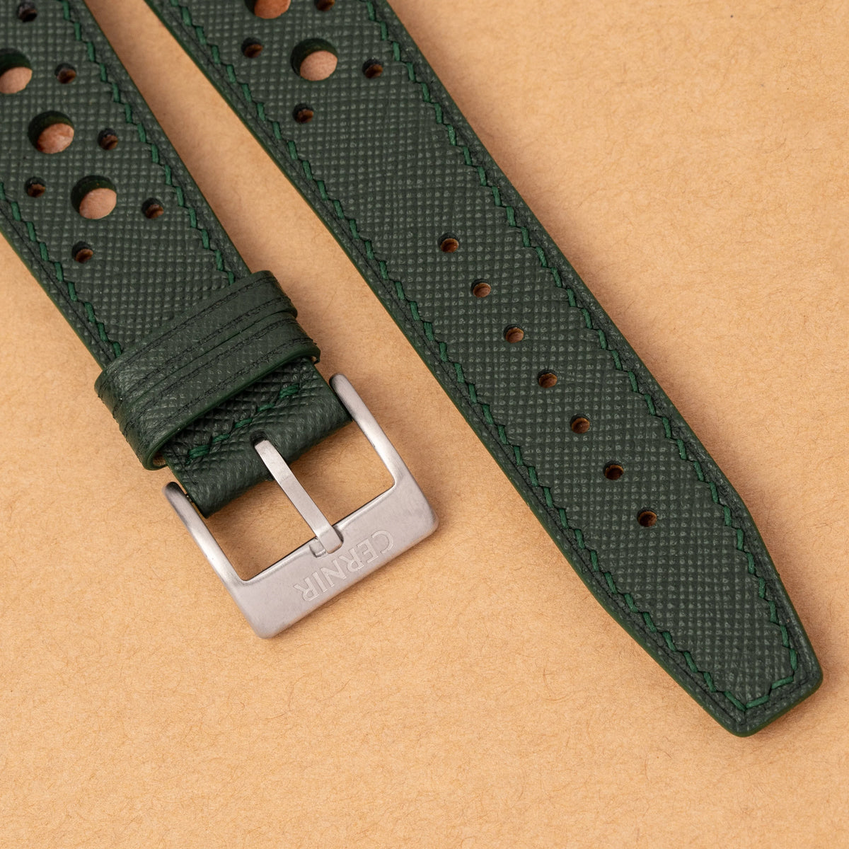 Close-up of the forest green Saffiano Hybrid Rally Pilot strap showing its round holes, tonal stitching and brushed steel buckle
