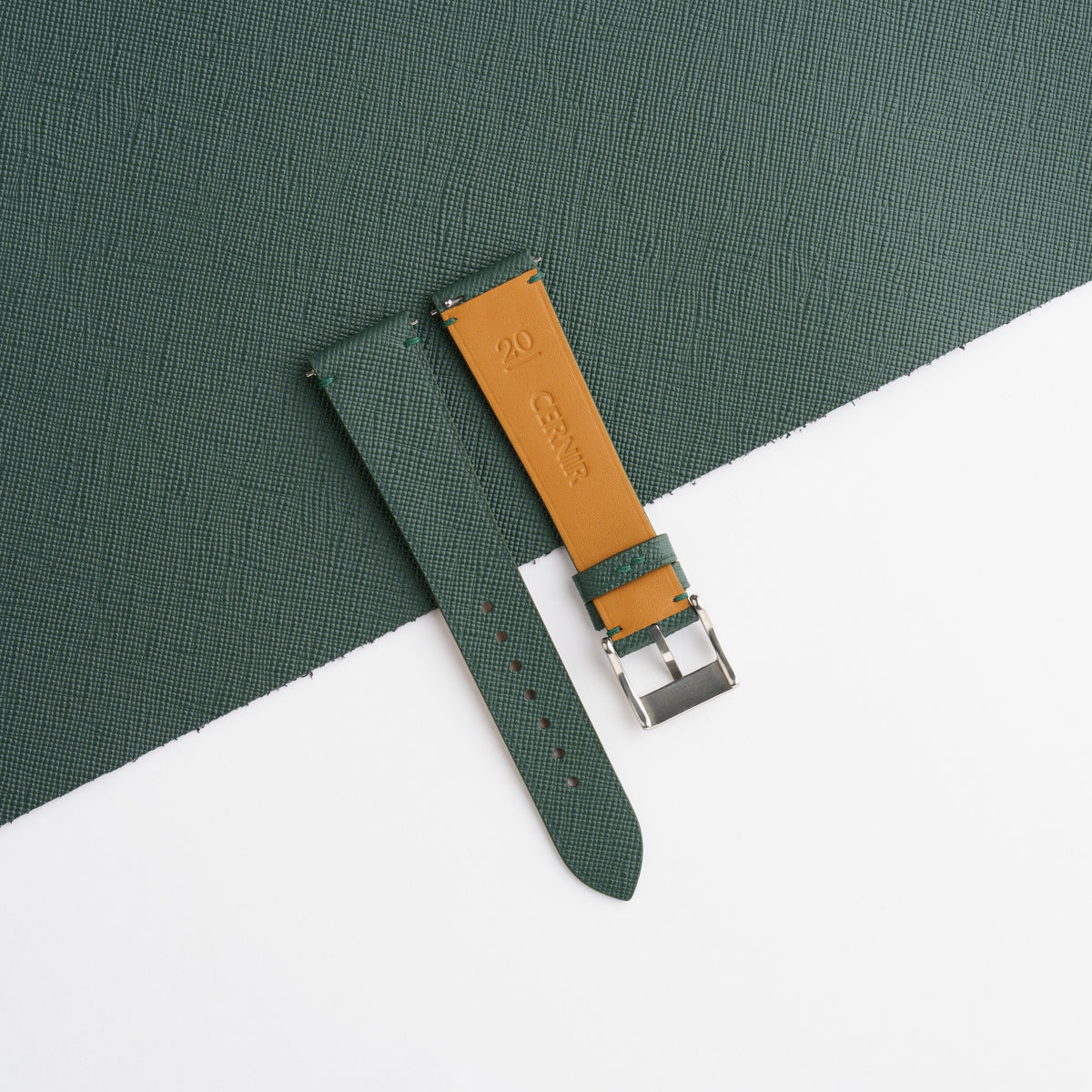 Golden tan Zermatt leather lining on the back of the forest green Saffiano side-stitch strap
