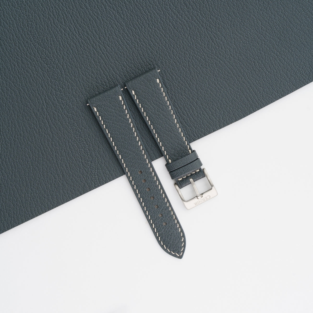 Grey Alran Chevre Sully slim watch strap laid on a matching grey goatskin sheet