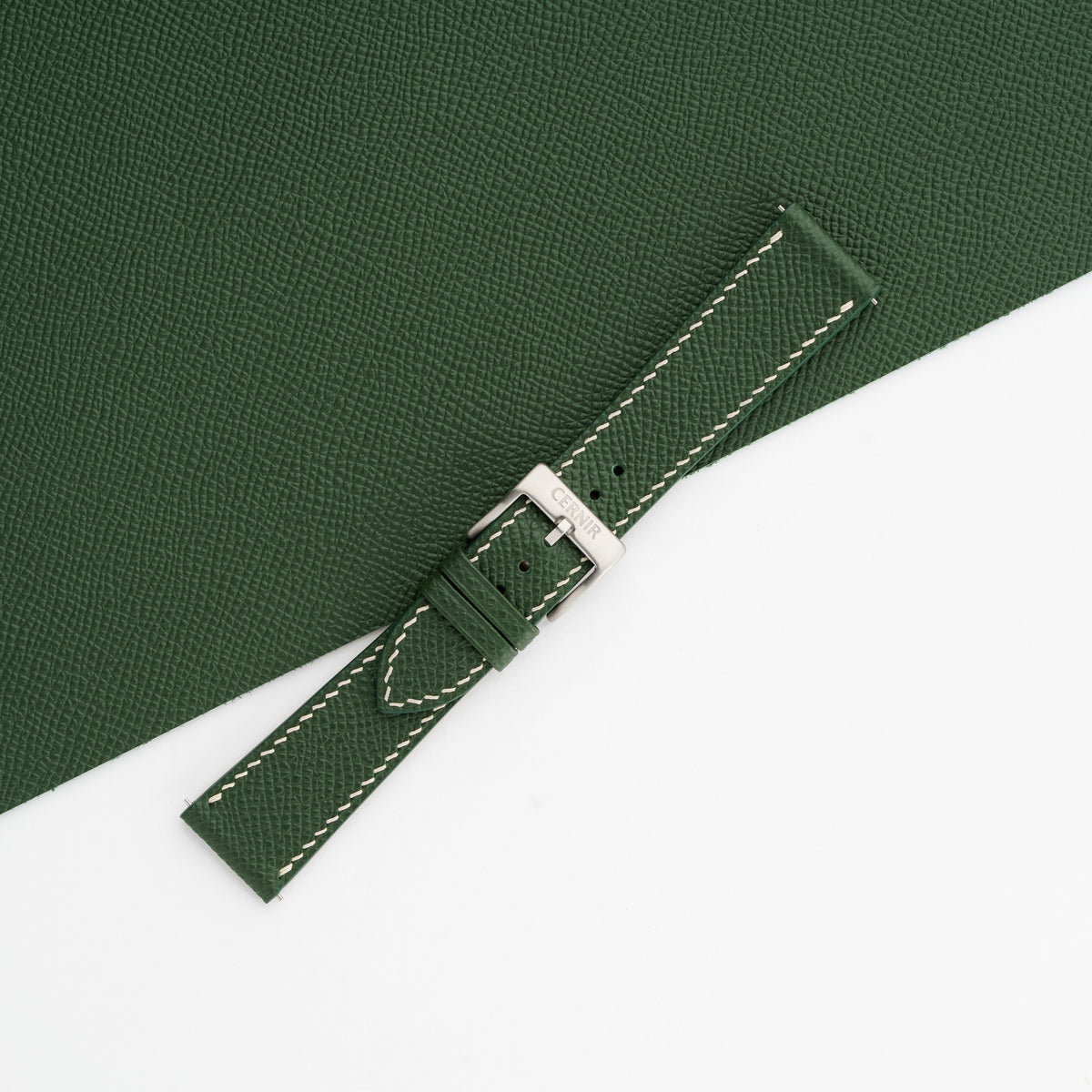 Buckled forest green Epsom slim watch strap on matching leather, showing the fine embossed grain