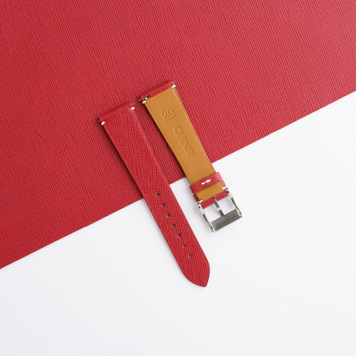 Golden tan Zermatt leather lining on the back of the red Saffiano side-stitch strap