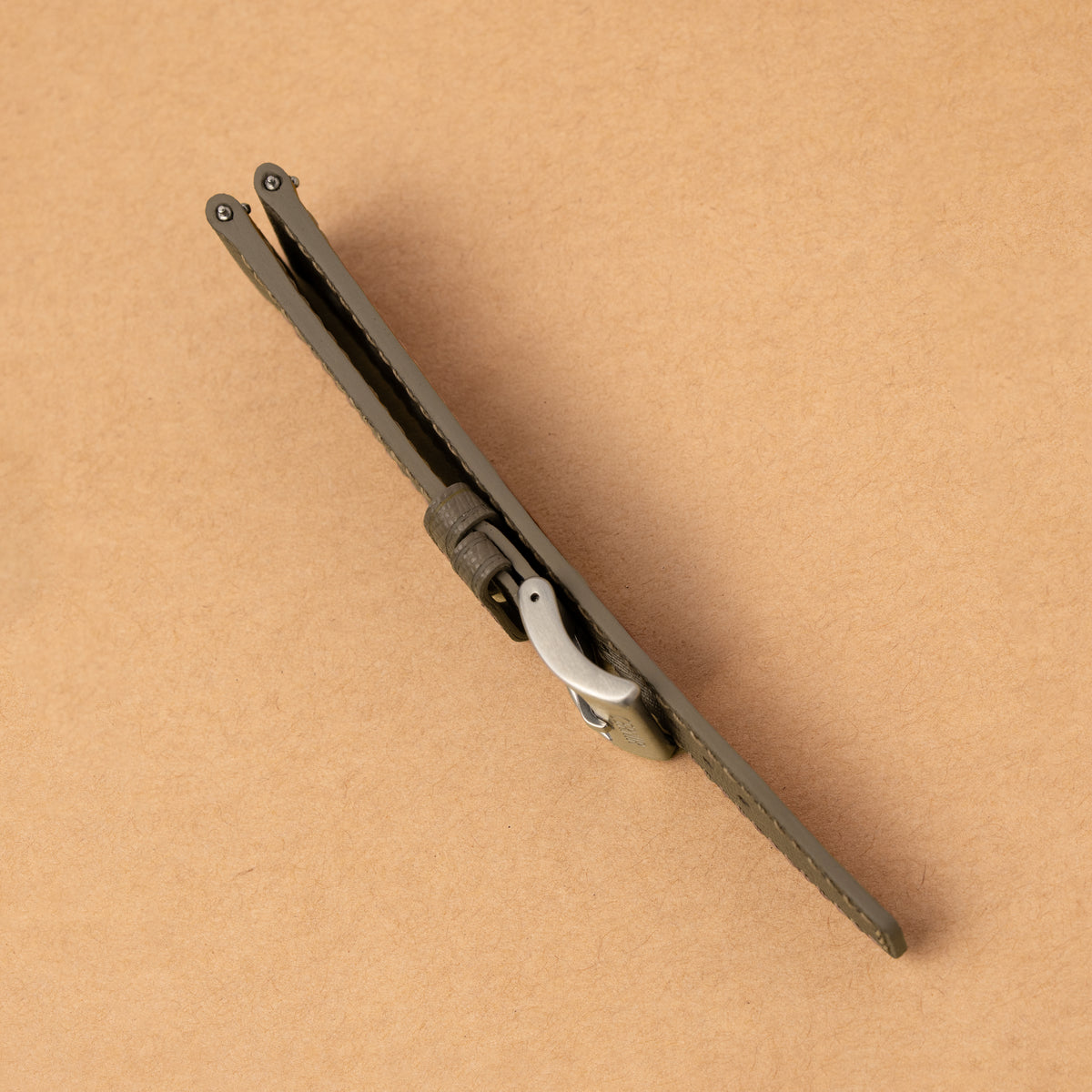 Side view of the taupe Saffiano Hybrid Rally Pilot strap folded, showing its edge profile