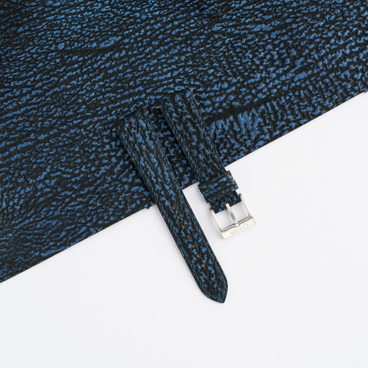 Black blue shark slim watch strap laid on matching black and blue shark leather