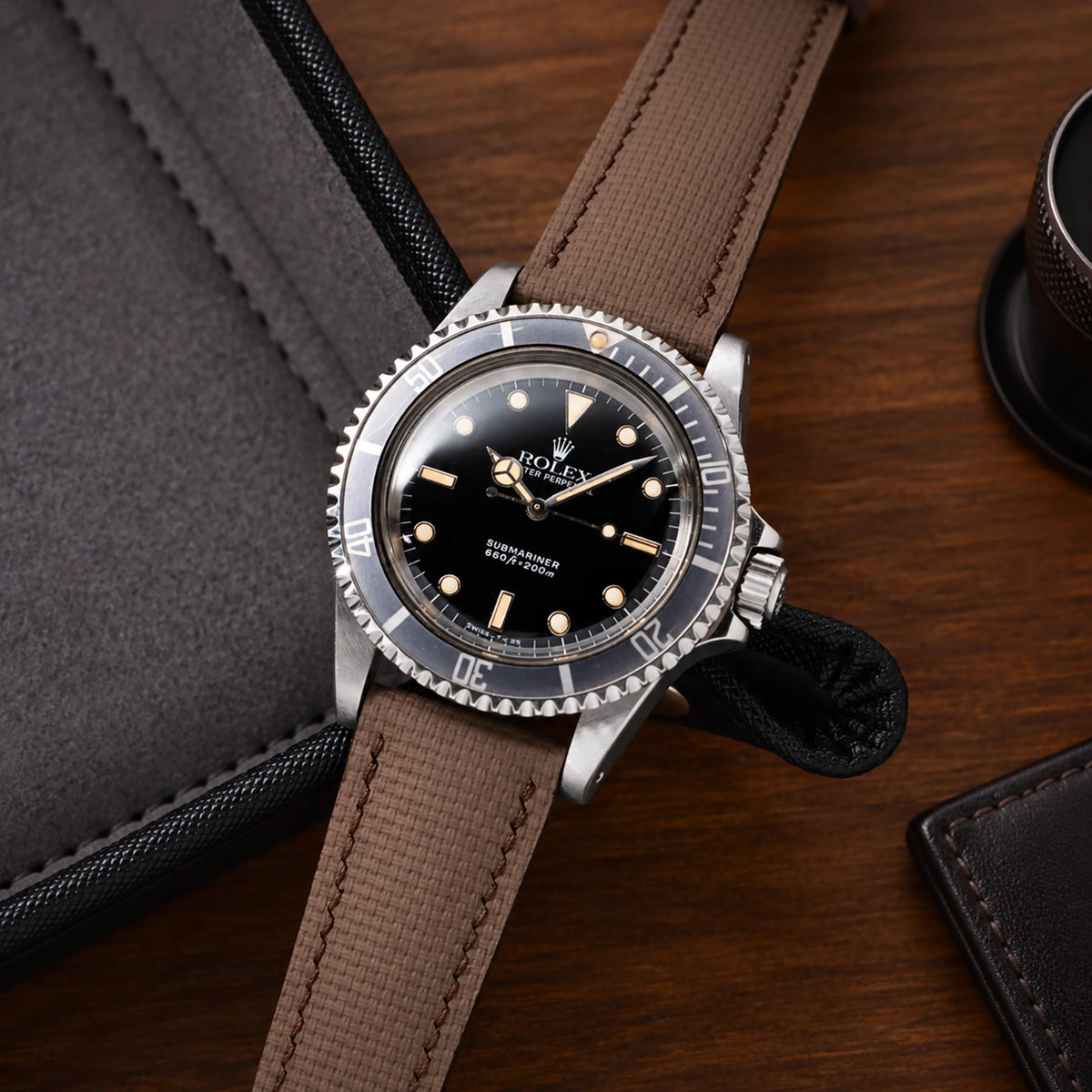 Brown sailcloth padded watch strap fitted to a vintage Rolex Submariner with a black dial