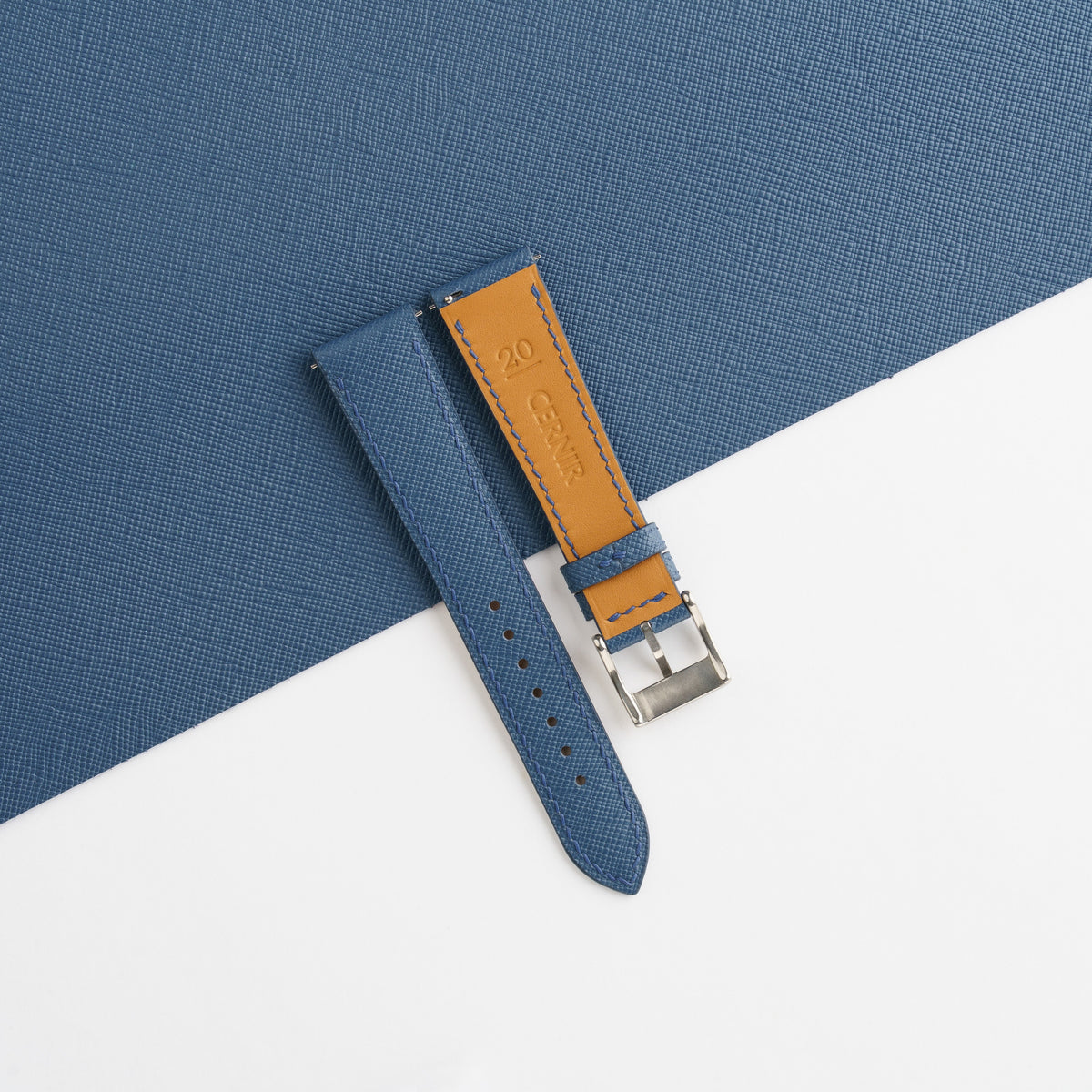 Zermatt leather lining and Cernir stamp on the back of the denim blue Saffiano slim strap