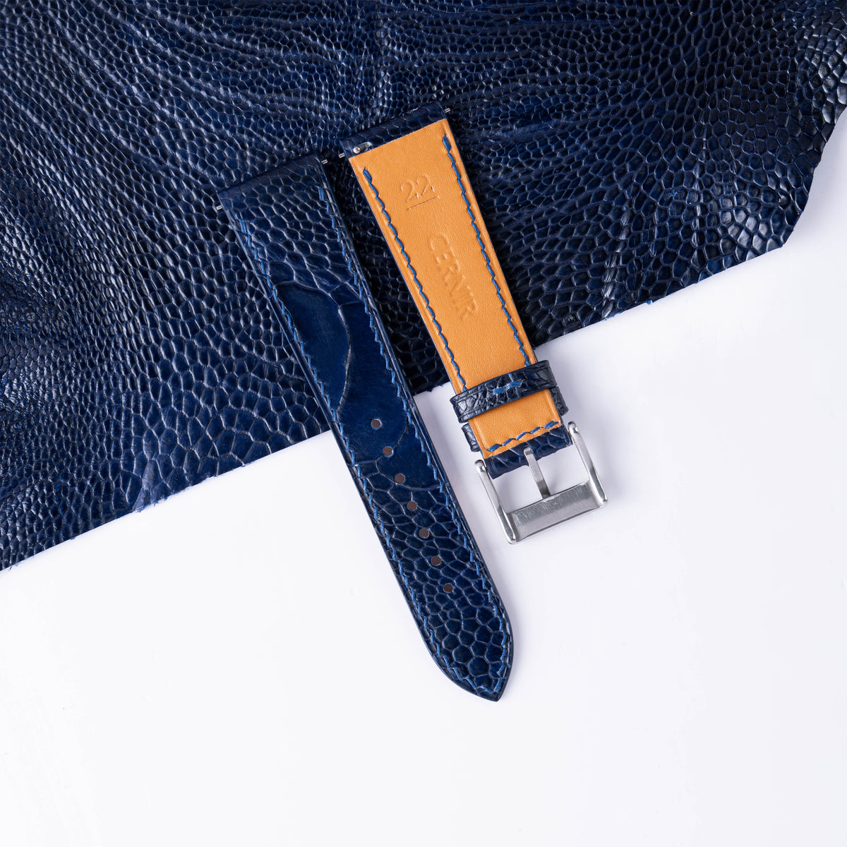 Back of the navy ostrich slim strap showing tan Zermatt lining and blue stitching