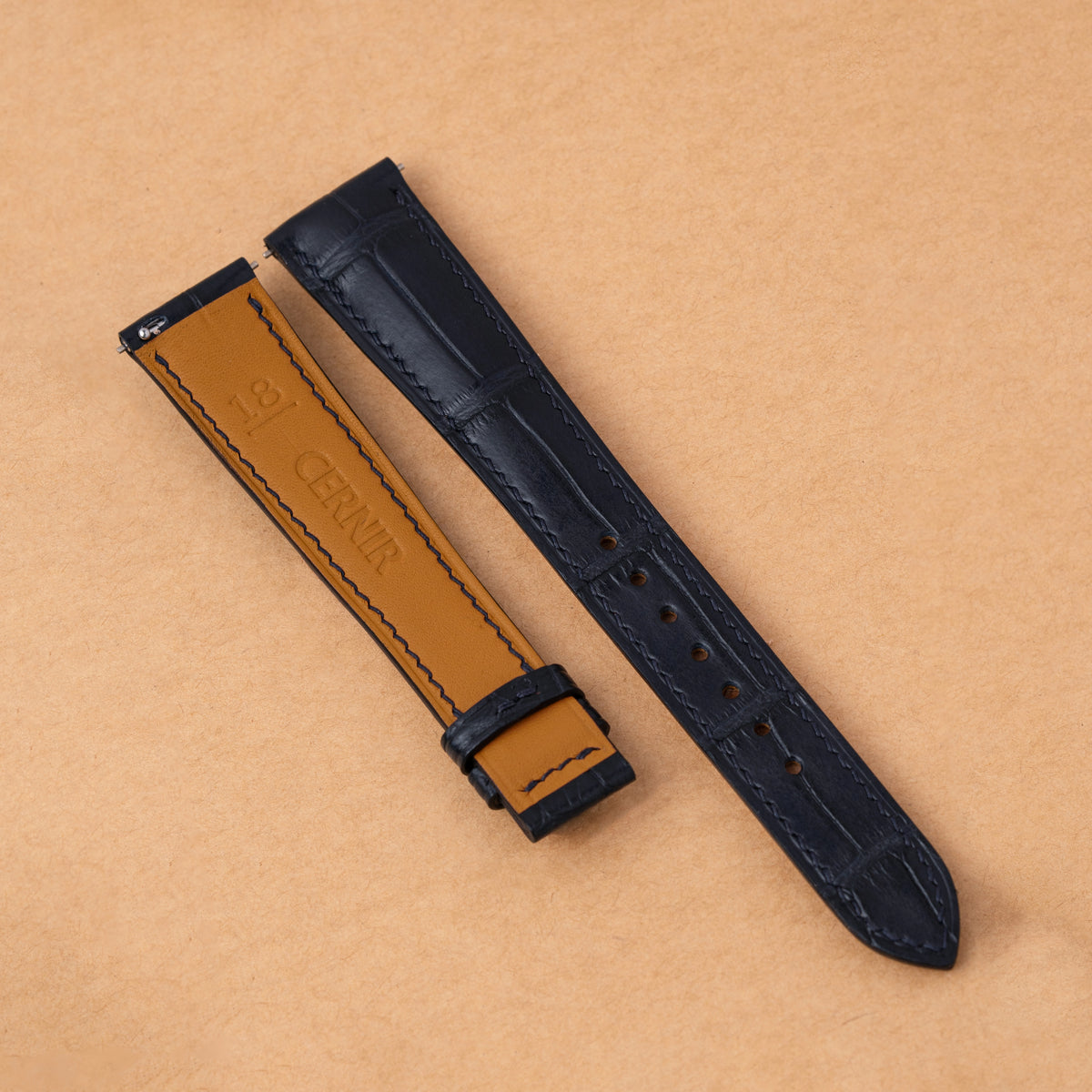 Tan Zermatt leather lining on the back of the navy alligator padded strap
