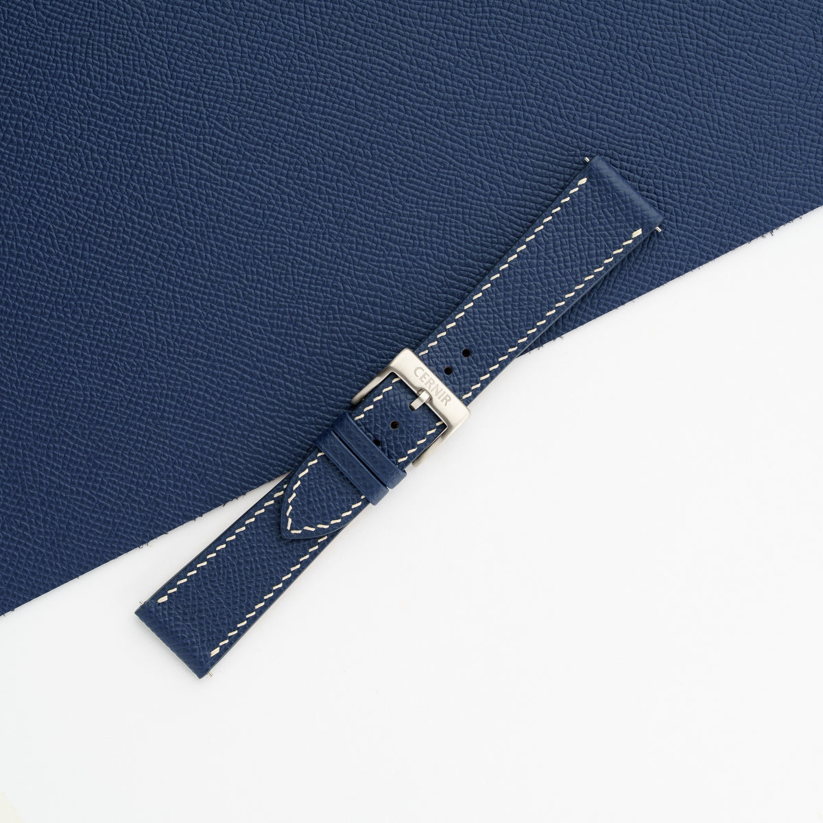 Buckled navy Epsom slim watch strap on matching leather, showing the fine embossed grain
