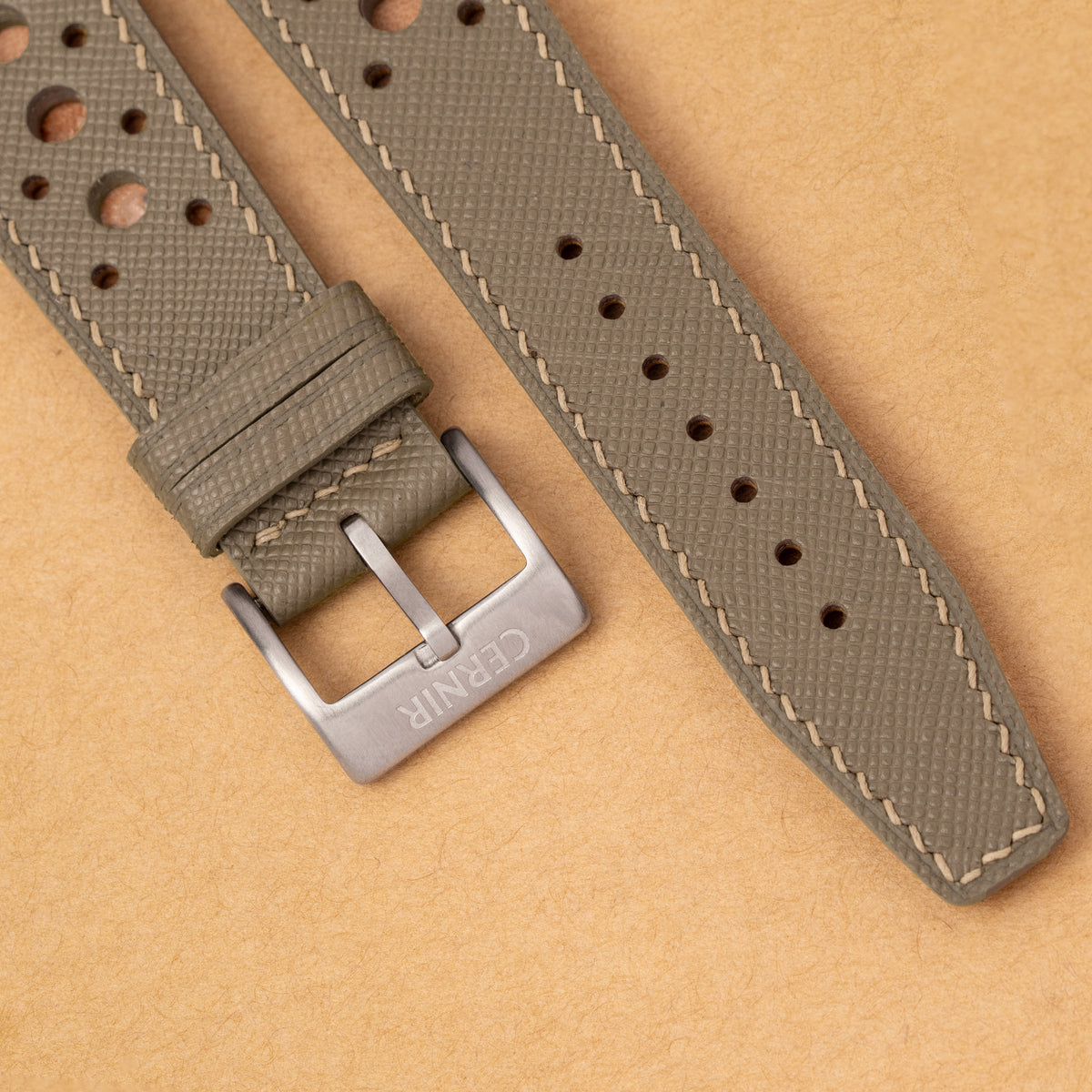 Close-up of the stitching, perforations and the steel buckle on the taupe Hybrid Rally Pilot strap
