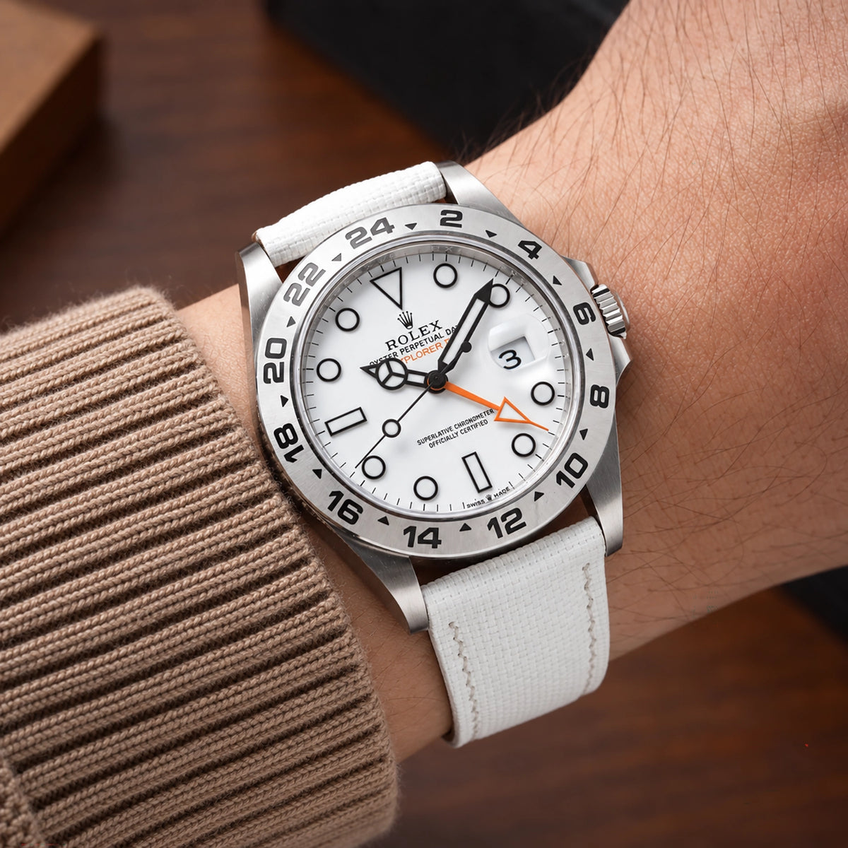 White sailcloth padded watch strap fitted to a Rolex Explorer II with a white dial