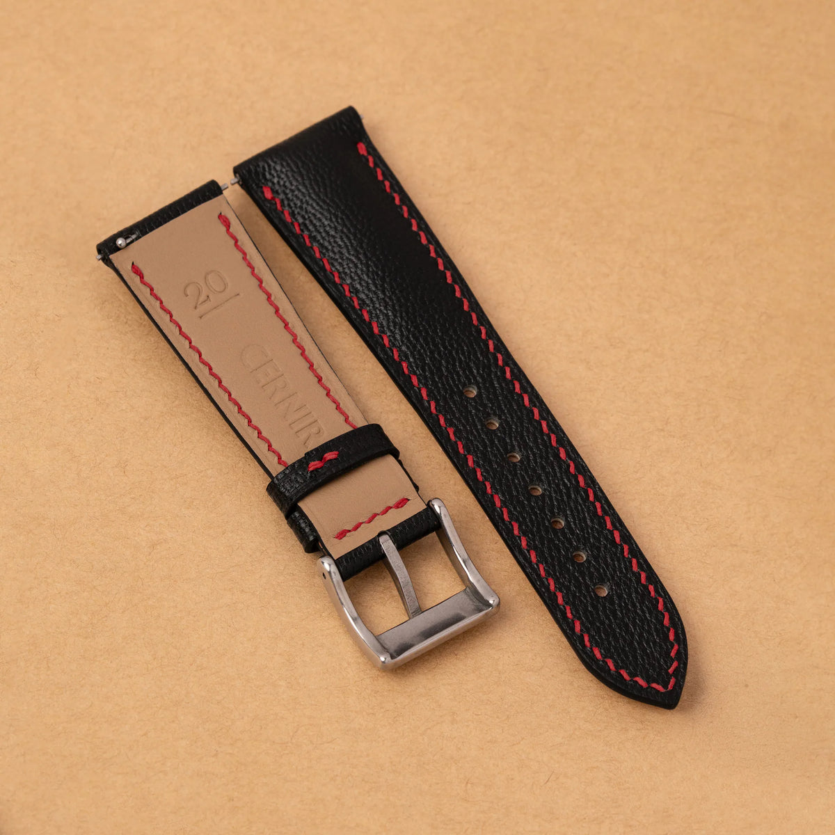 Zermatt Beige leather lining with the Cernir stamp and red stitching on the back of the black Alran padded strap