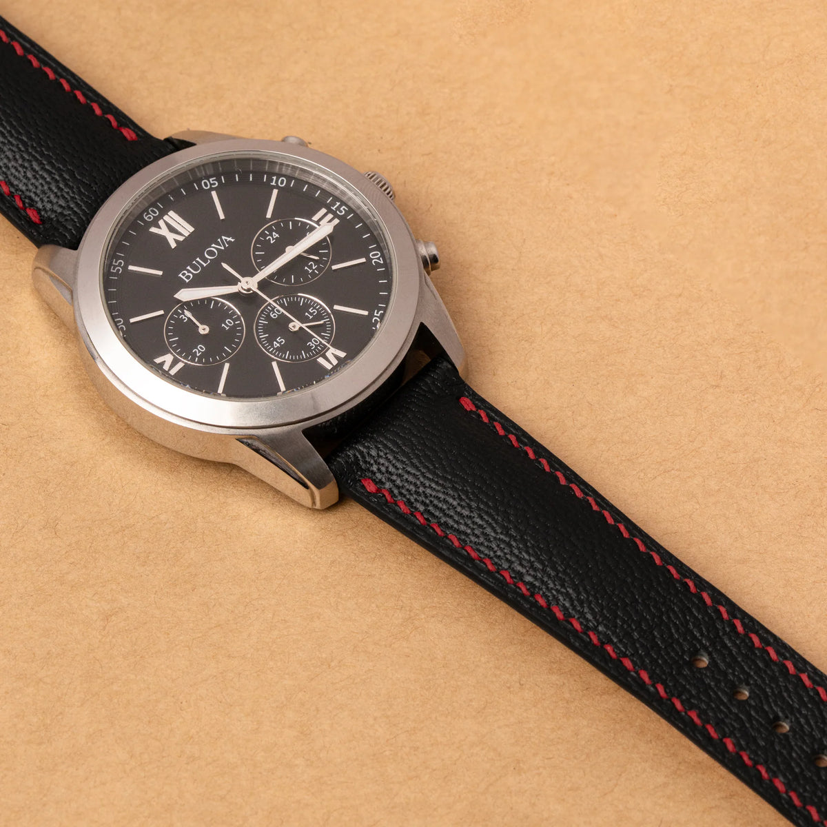 Black Alran Chevre Sully padded strap with red stitching on a Bulova chronograph with a black dial