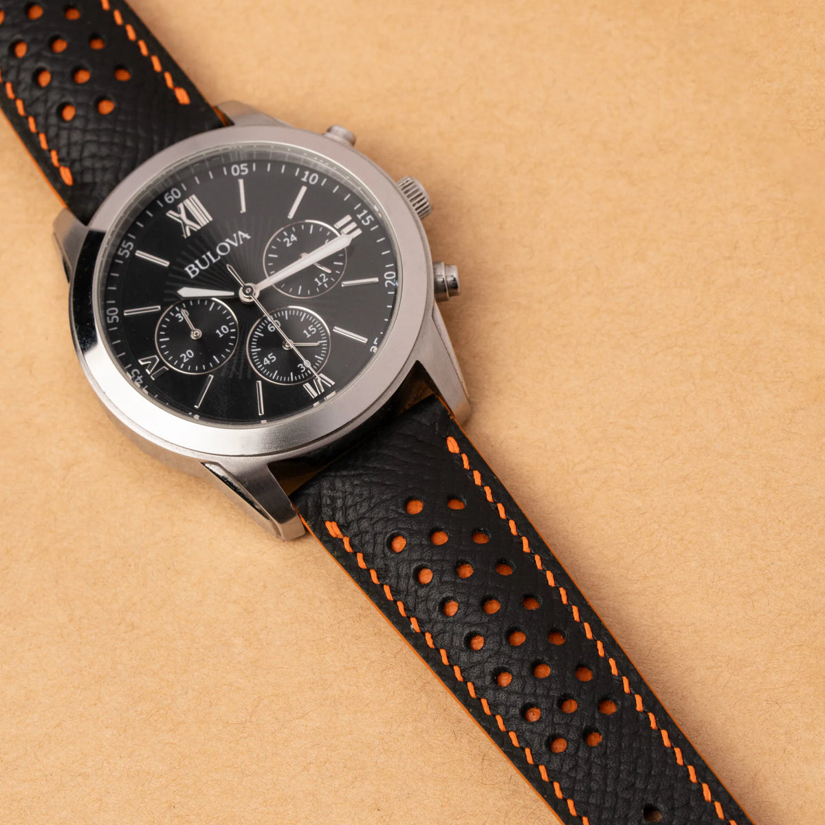 Black Epsom Racing Rally strap with orange stitching on a Bulova chronograph with a black dial