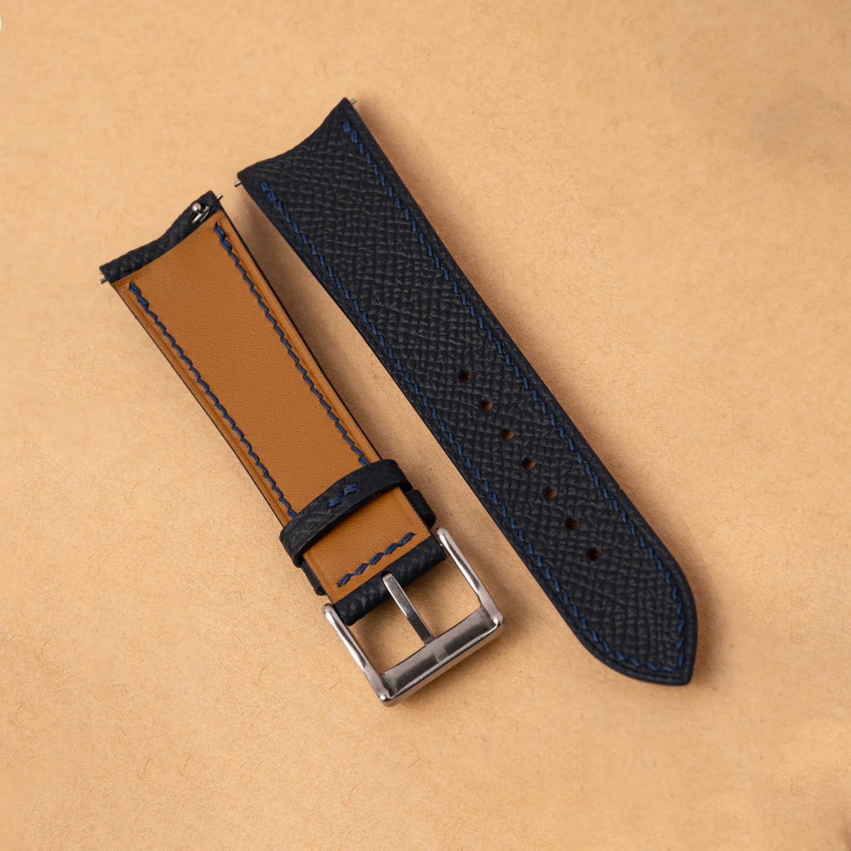 Golden Zermatt leather lining with navy stitching on the back of the black Epsom slim curved end strap