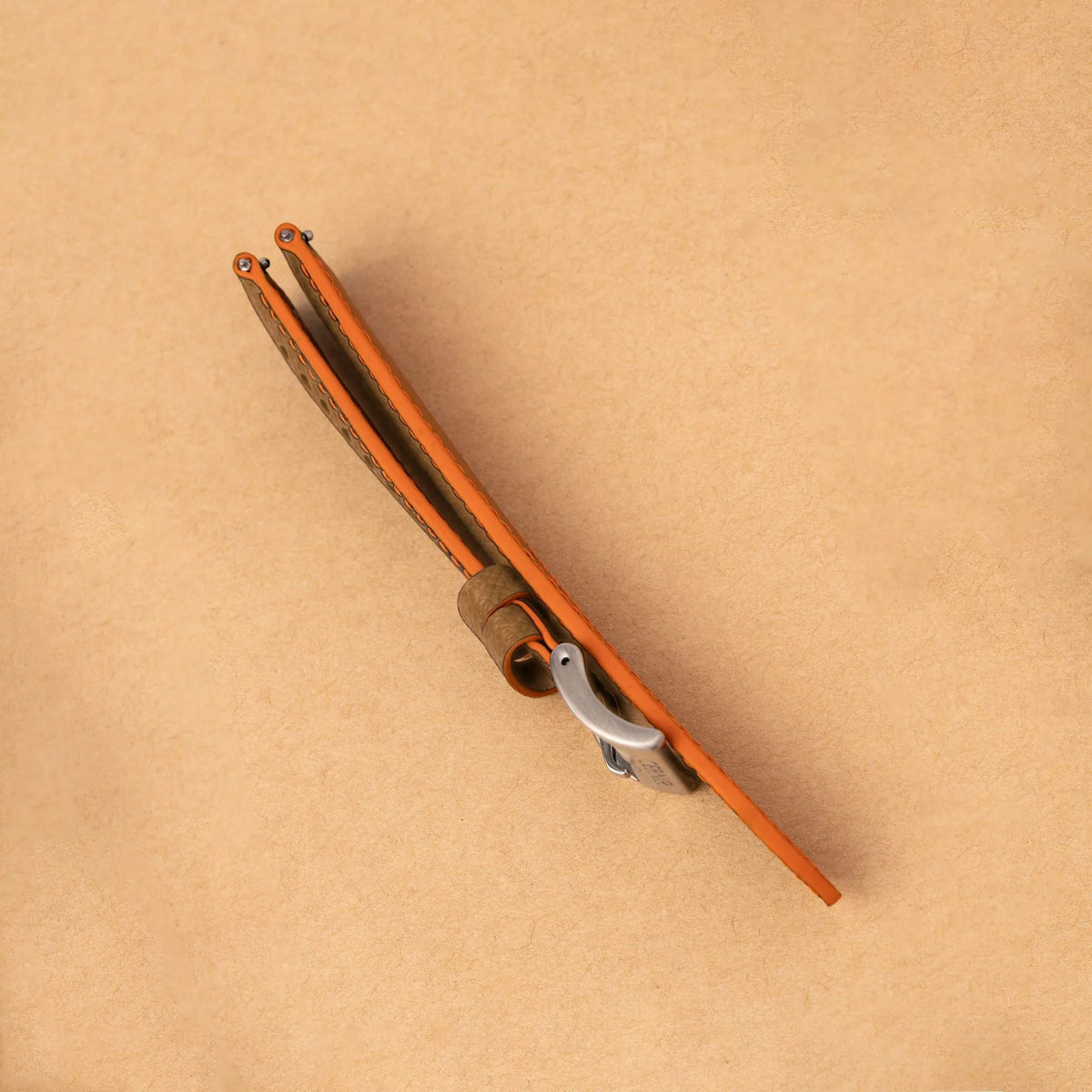 Side view of the padded camel Epsom Racing Rally strap, showing its orange painted edges