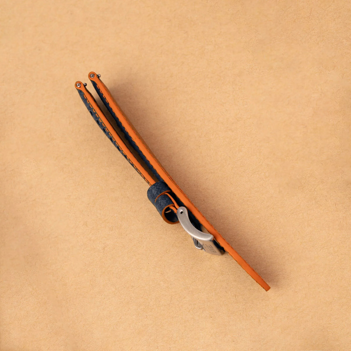 Side view of the padded dark navy Epsom Racing Rally strap, showing its orange painted edges
