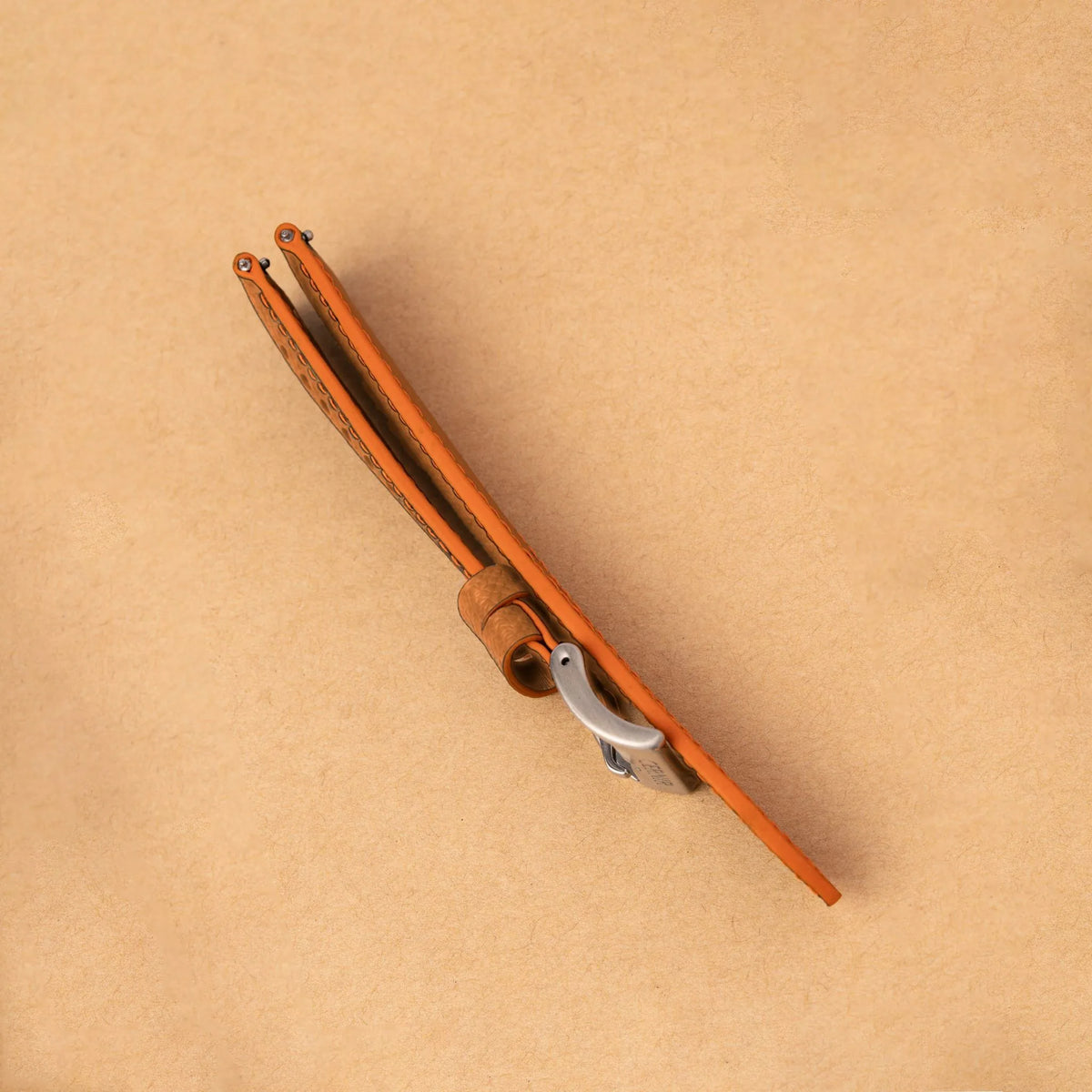 Side view of the padded golden brown Epsom Racing Rally strap, showing its orange painted edges