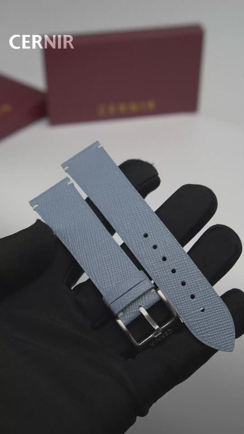 Video: Dusty Blue Saffiano Leather Side-Stitch Watch Strap held in a gloved hand, showing both pieces and the buckle