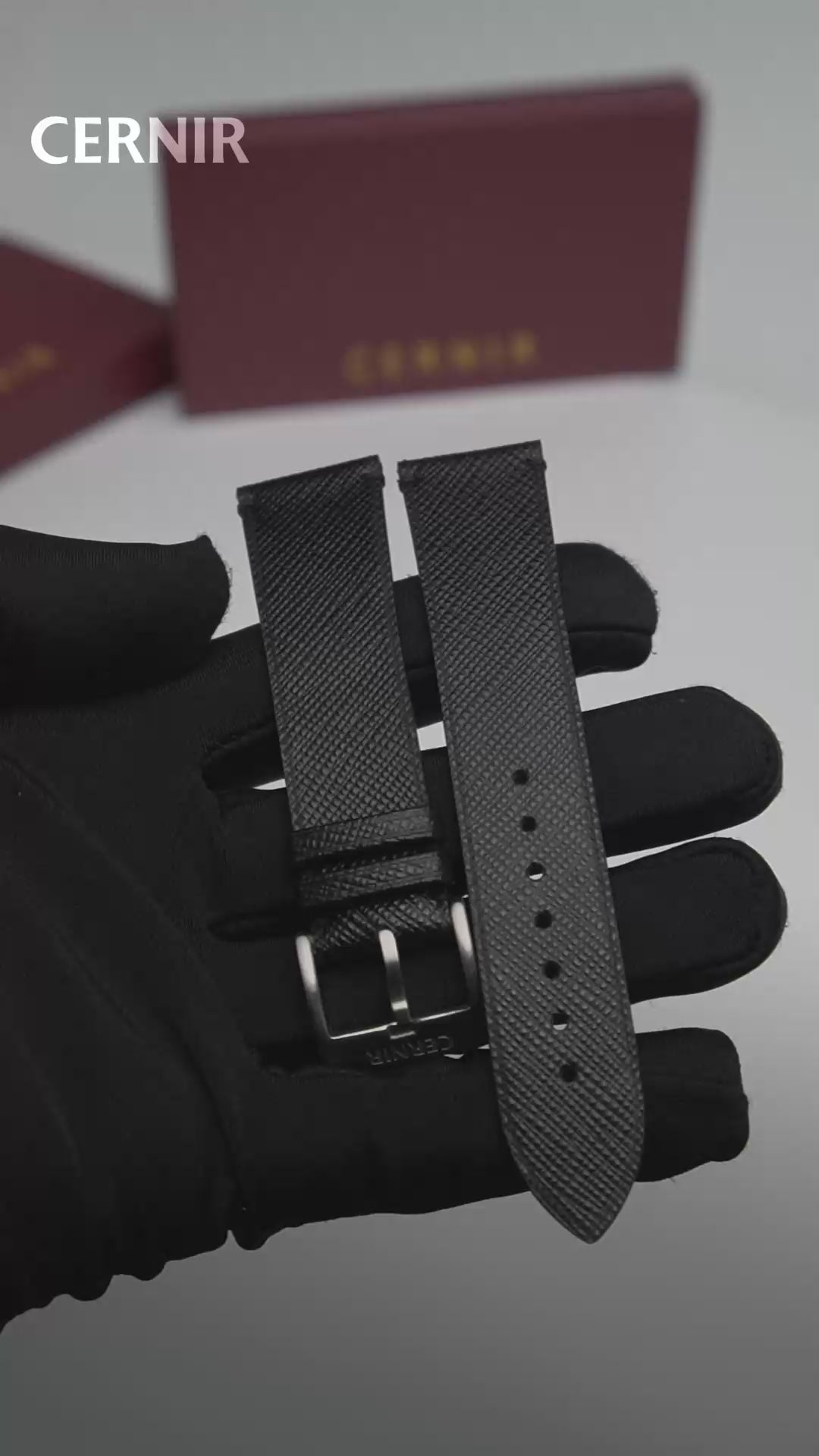 Video: Black Saffiano Leather Side-Stitch Watch Strap held in a gloved hand, showing both pieces and the buckle