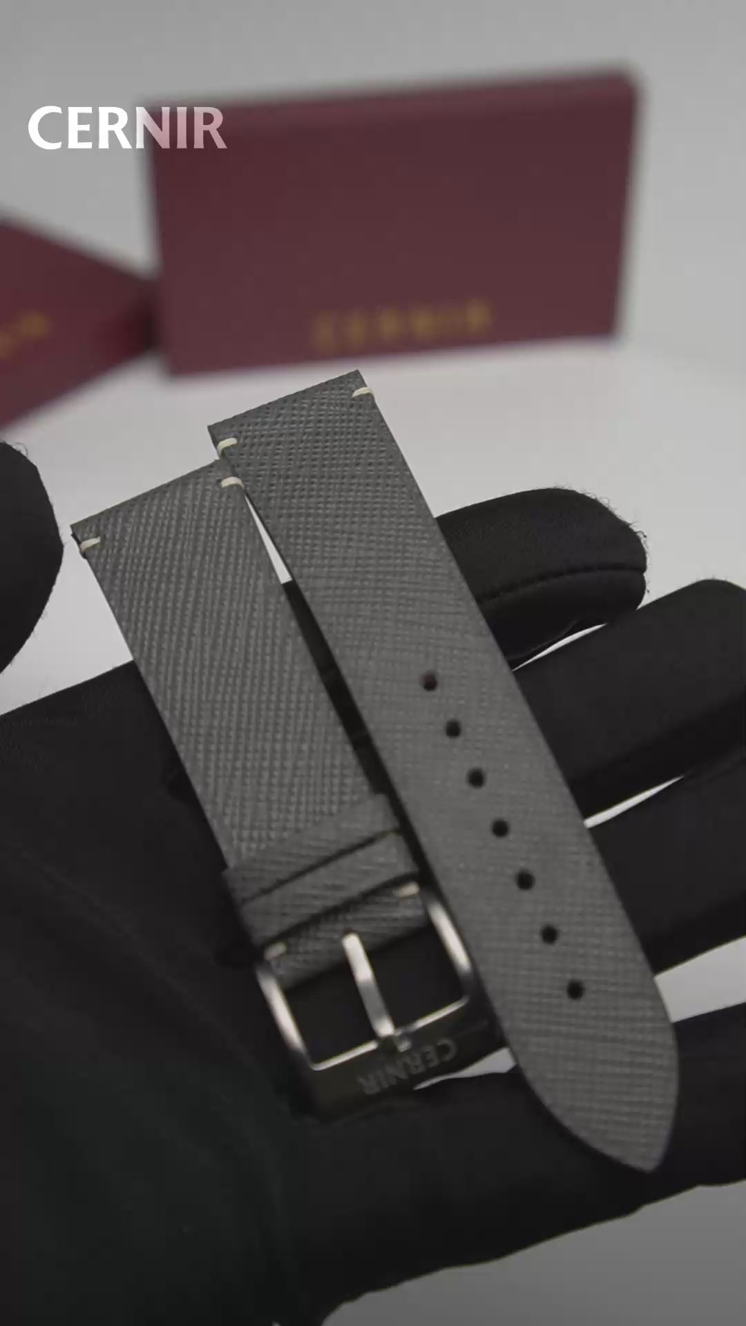 Video: Grey Saffiano Leather Side-Stitch Watch Strap held in a gloved hand, showing both pieces and the buckle