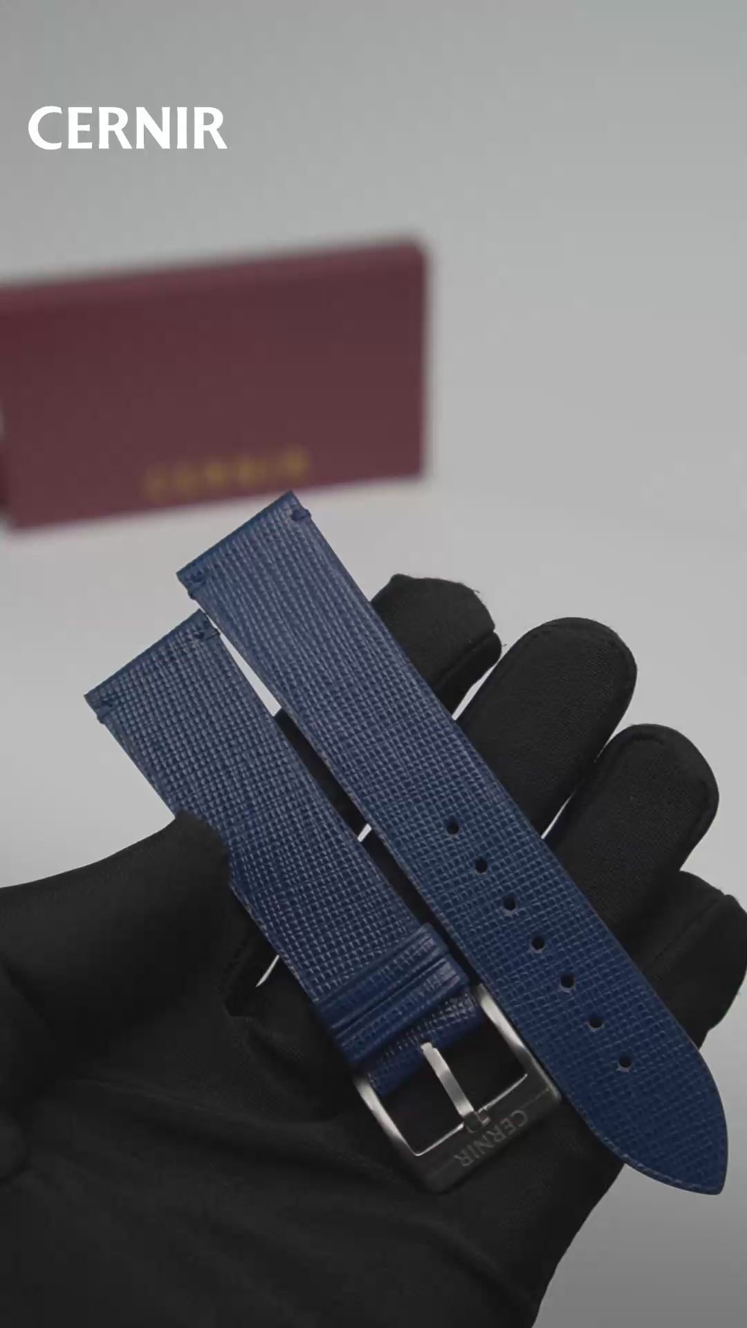 Video: Blue Saffiano Leather Side-Stitch Watch Strap held in a gloved hand, showing both pieces and the buckle