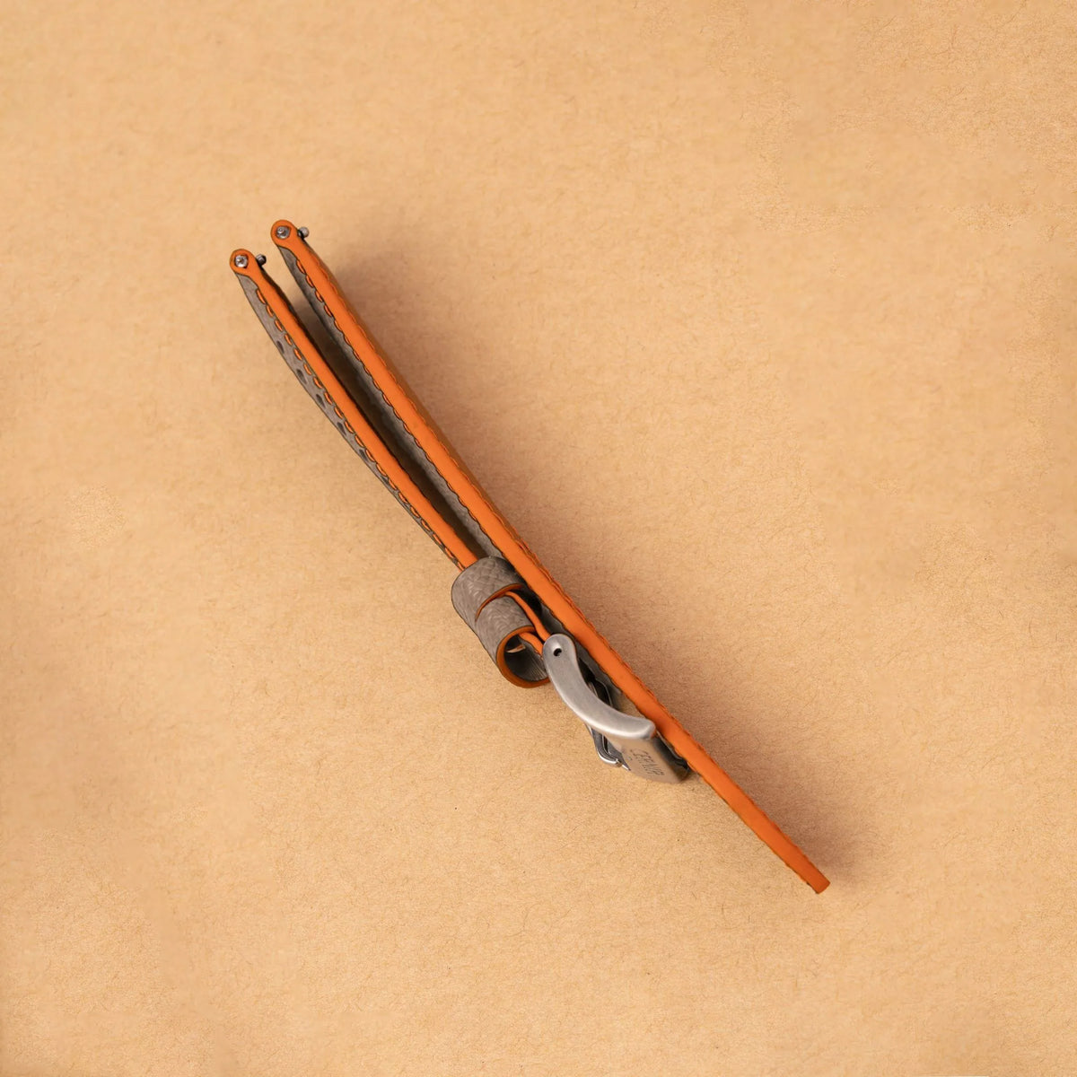 Side view of the padded taupe Epsom Racing Rally strap, showing its orange painted edges